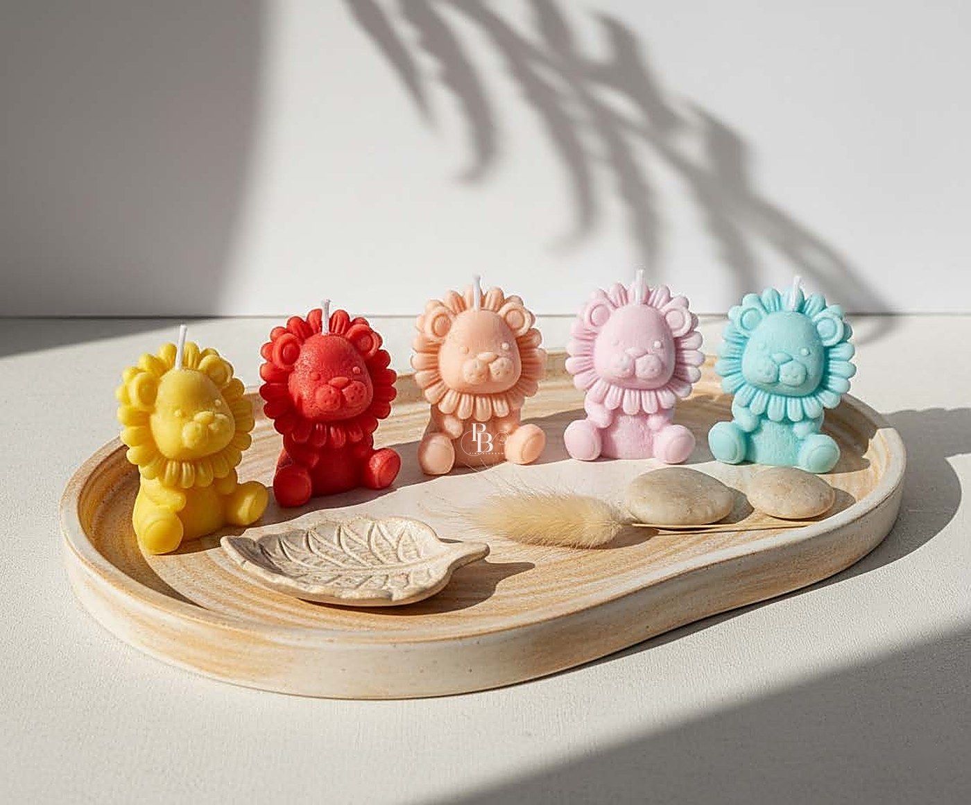 Colourful lion candles lined up on a wooden tray, handmade soy wax, Pink Blossom bulk order