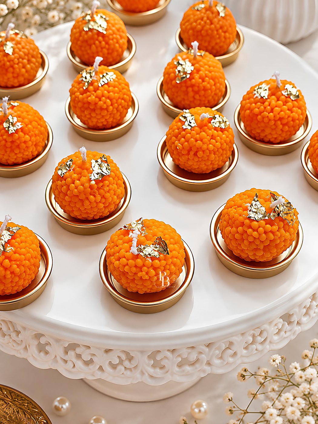 Orange ladoo candles with silver leaf on small gold urli plates, Ladoo with Urli Plate, handmade soy wax, Pink Blossom bulk order